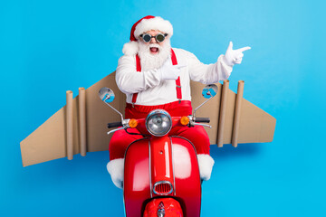 Stylish modern white grey hair bearded santa claus drive magic scooter sky point finger x-mas party...