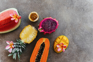 Fresh healthy tropical fruits, melon, pineapple, mango, bananas, dragon fruit Summer food vitamins concept