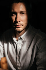 young attractive man looking and thinking. portrait of handsome man sitting in cafe