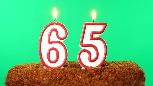 Cake with the number 65 lighted candle. Chroma key. Green Screen. Isolated