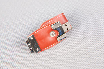 USB devices key for data storage made of leather and metal on white background