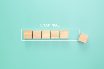 Showing loading bar with wood cube on pastel background. Progress bar made from wooden cubes....