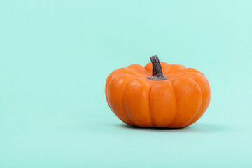 Pumpkins over neo mint background. Autumn, Halloween concept.Copy space for text.