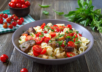 Pasta creste with grilled eggplant, cherry tomatoes and herbs. Delicious warm salad.