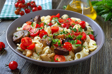 Pasta creste with grilled eggplant, cherry tomatoes and herbs. Delicious warm salad.