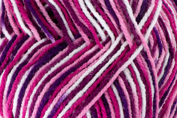 Closeup of textured knitting yarn, soft and fluffy wool in pinks and purples