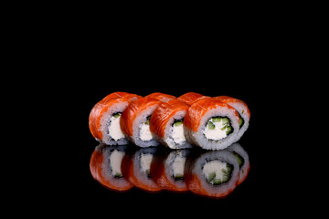Fresh delicious beautiful sushi rolls on a dark background