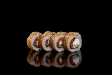 Fresh delicious beautiful sushi rolls on a dark background