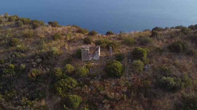 Flying back over ancient ruins on sea coast line