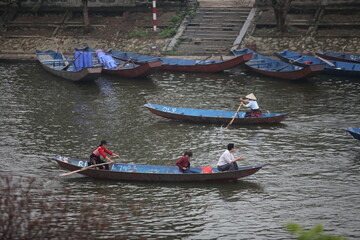 Obraz premium HANOI, VIETNAM - MARCH 30, 2015: Tourist sit on boat to visit HUONG Pagoda. HUONG Pagoda Festival is the biggest and longest annual festival in Vietnam. The festival is opened in MY DUC district