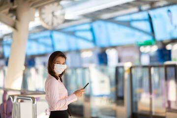 Asian businesswoman using phone in station