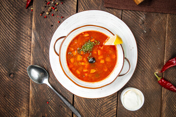 Russian soup solyanka with smoked meats 