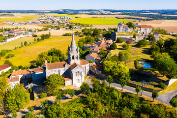 Drone view of medieval chateau and church in French village of Villebois-Lavalette on sunny summer...