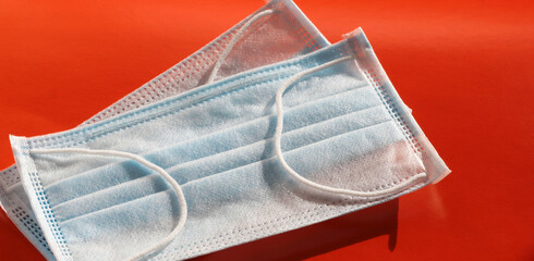 Medical masks on a red background. Respiratory protection.