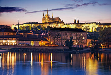 Skyline of Prague overlooking the  illuminated at dusk