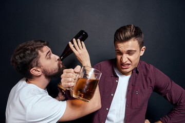 Two drunk friends drinking beer rest fun dark background