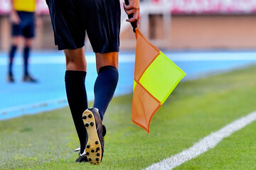 Assistant referee or Lineman of football or soccer holding a flag © Filip