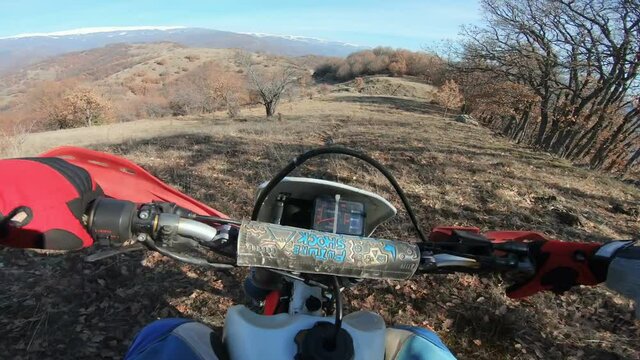 Enduro bike rider on a di. Rt road. The motorcycle skids and drives dangerous