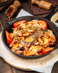 Closeup on roasted shrimps in cast iron pan