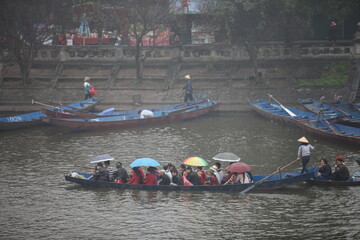 HANOI, VIETNAM - MARCH 30, 2015: Tourist sit on boat to visit HUONG Pagoda. HUONG Pagoda Festival is the biggest and longest annual festival in Vietnam. The festival is opened in MY DUC district