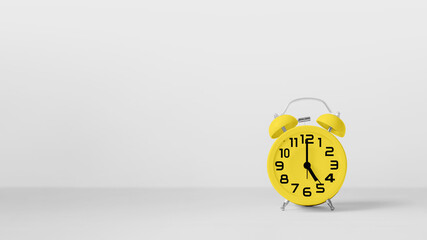Yellow vintage alarm clock on white background.
