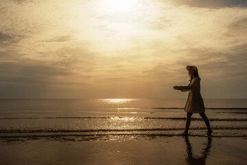 cheerful woman in bikini walking on sea beach