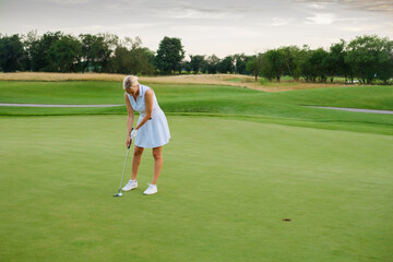 Sportsman Woman Tries Put Ball Into Golf Hole .