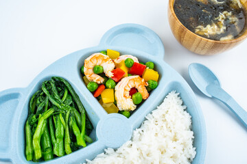 A plate of nutritious children's meal on white background