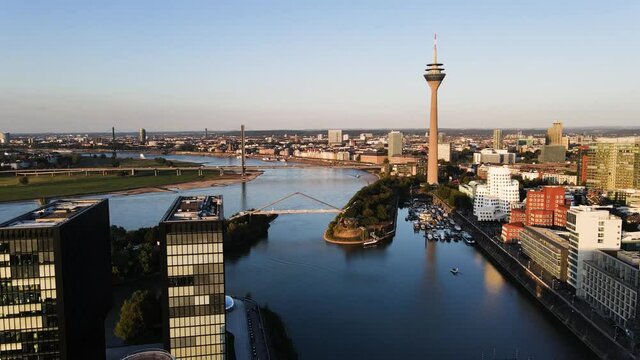 Düsseldorf, Germany - drone shot of the media harbour/ cityscape while sunset.
