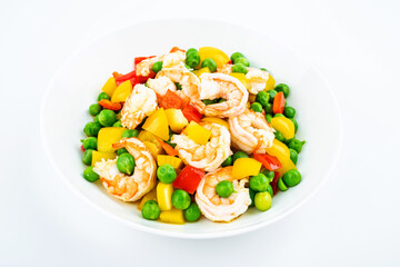 Fried shrimps with peas on a dish on white background