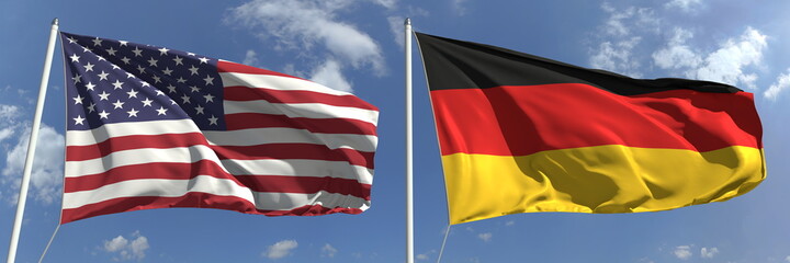 Flags of the USA and Germany on flagpoles. 3d rendering