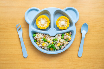 A plate of children's nutritious luncheon meat fried rice on the table