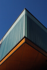 Fototapeta na wymiar Abstract View of Corner of Modern Building seen from Below against Blue Sky 