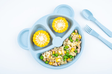 Nutritional meal for children on a plate on white background