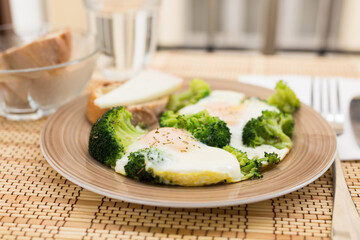 breakfast of crumpled eggs with broccoli