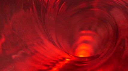 Symbol of hell, inferno and infinity. Red liquid hypnotic looped aqua swirl turning. Meditative luminous whirlpool. Mesmerising spiral tunnel of crystal fluid. Fiery surreal rhythmic water gradient