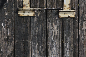 Old hinges and grunge dark textured wooden background