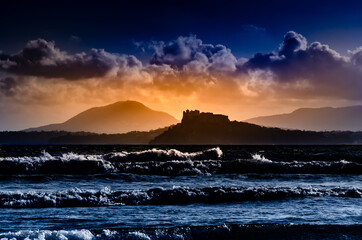 Island of Procida, Campania region, Italy. Image of the island at sunset with a castle silhouette...