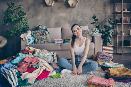 Full size photo of positive cheerful girl sit carpet legs crossed folded enjoy routine household laundry iron fabric dressing outfit in house indoors