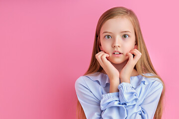 scared surprised girl look at camera, emotionally reacts on something, isolated pink background