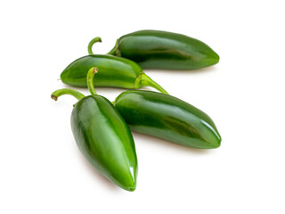Shiny green jalapeno pepper pods on a white background