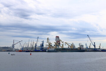 Fototapeta premium August 21 2020 - Rostock-Warnemünde, Mecklenburg-Vorpommern/Germany: Details of the industry port and dockside cranes at the europort harbour in Rostock