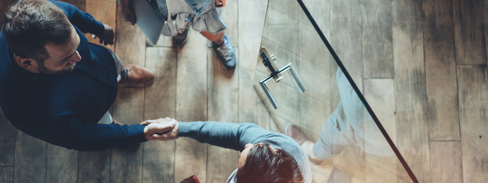 Business office concept. Successful meeting, handshake, top view. Wide screen, panoramic