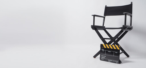 Director chair with black and yellow clapper board or movie slate on white background.it is used in video production and film industry.