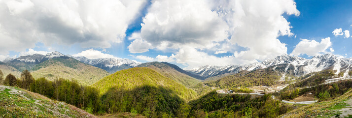 Obraz na płótnie Canvas Spring mountain landscape. Ski resort Krasnaya Polyana (Red Meadow). Panoramic picture. Sochi. Russia.