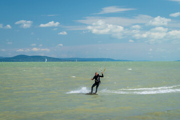 Kiteboarding at lake Balaton in the summer in Balatonfenyves near Fonyód in Hungary. Watersport, kite surfing