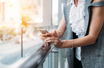 Unrecognizable business woman using mobile phone outside stock photo