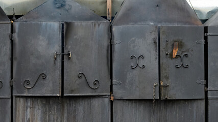 Aged, smokehouse smoking furnaces made from dark steel.