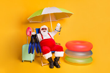 Full length photo of grey white hair bearded santa claus rest chill chaise-lounge show underwater...