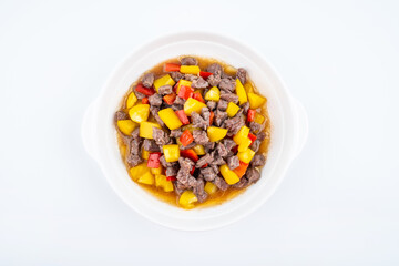 Obraz na płótnie Canvas Diced beef with bell pepper on a dish of home cooking on white background